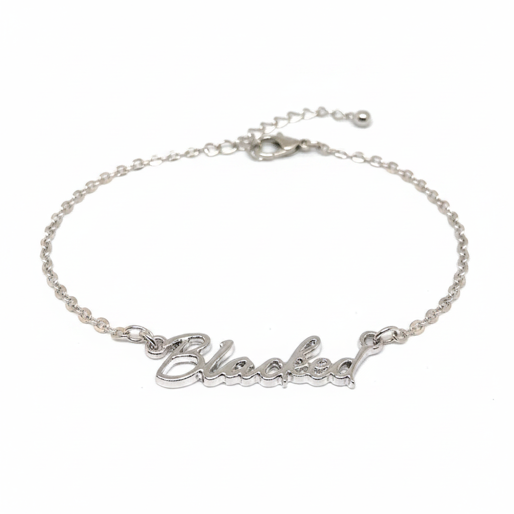 A silver chain anklet with the word 'Blacked' written in a cursive script.
