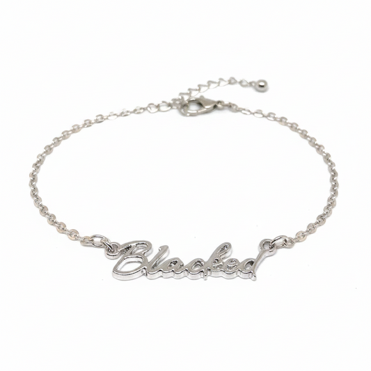 A silver chain anklet with the word 'Blacked' written in a cursive script.