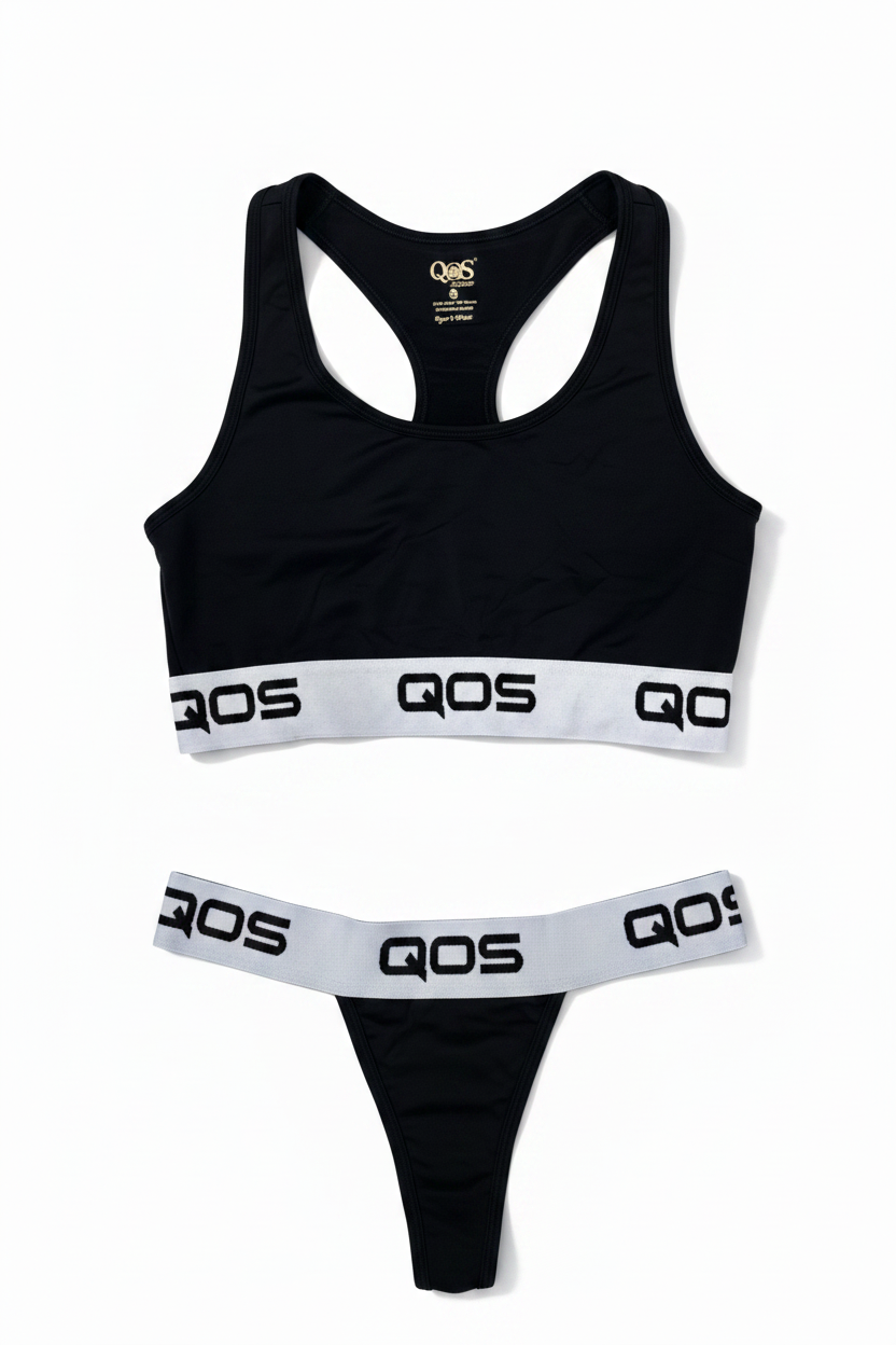 This image features a stylish and comfortable two-piece sports bralette set from the Queen of Spades (QOS) line. The set includes a sleek black sports bra adorned with the white QOS logo on both the front and back, enhancing its chic appeal.