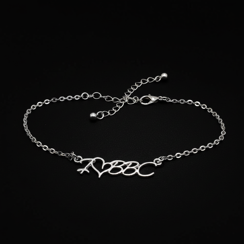 A silver chain bracelet featuring a central script charm spelling 'A3B3C' with a small heart and arrow motif, displayed on a clean white background.