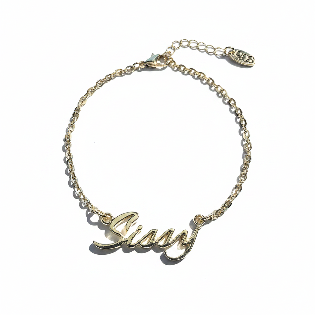 A gold-colored chain anklet with the word 'Sissy' written in a cursive script.