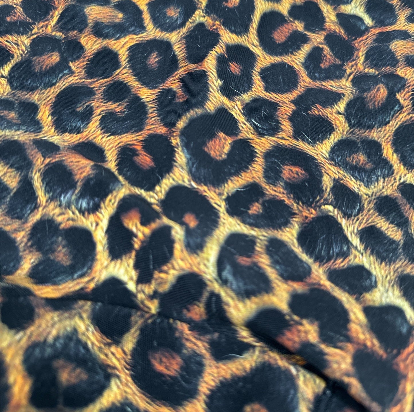 Leopard print pattern with visible branding at the top