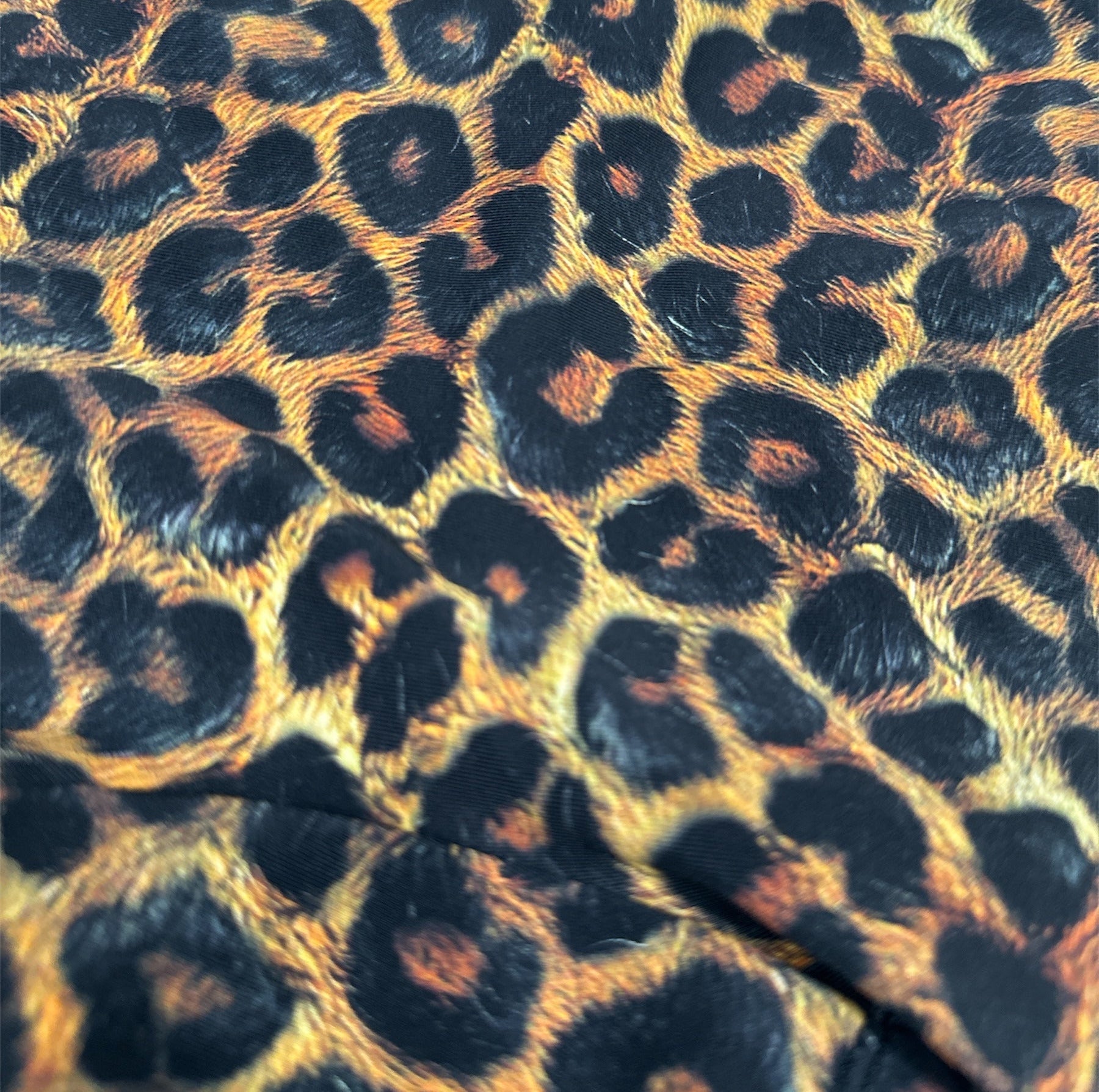 Leopard print pattern with visible branding at the top