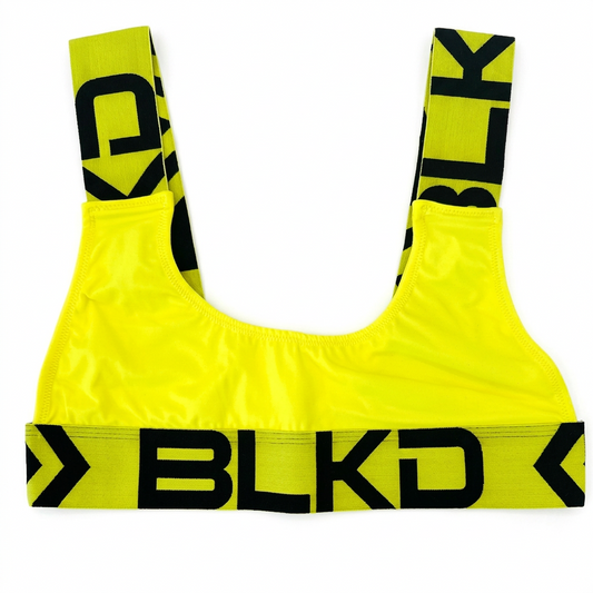 Yellow sports bra with black branding on a white background