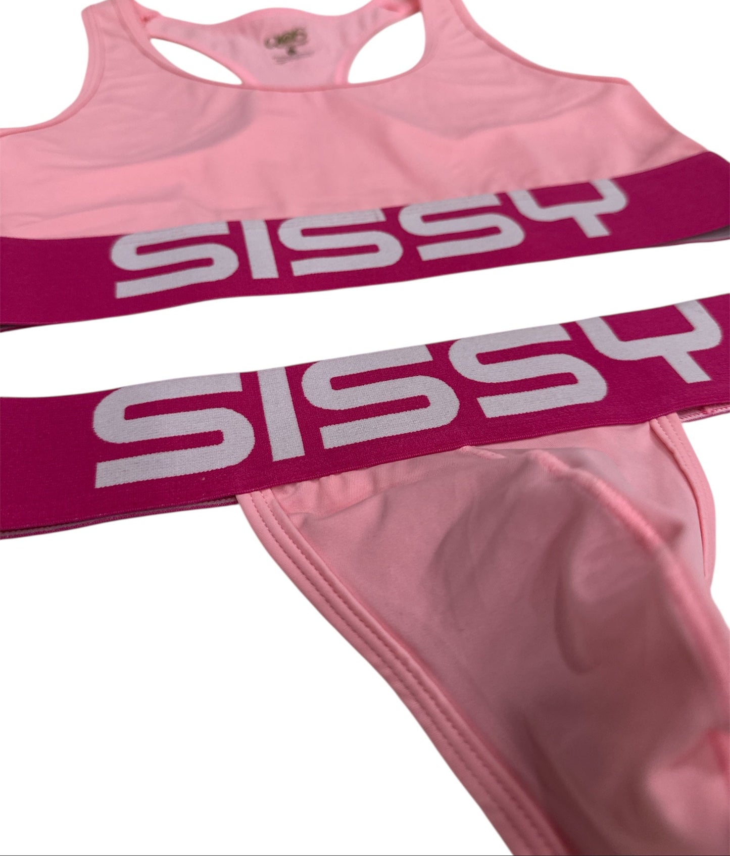 Pink sports bra and shorts with 'SISSY' text on a white background